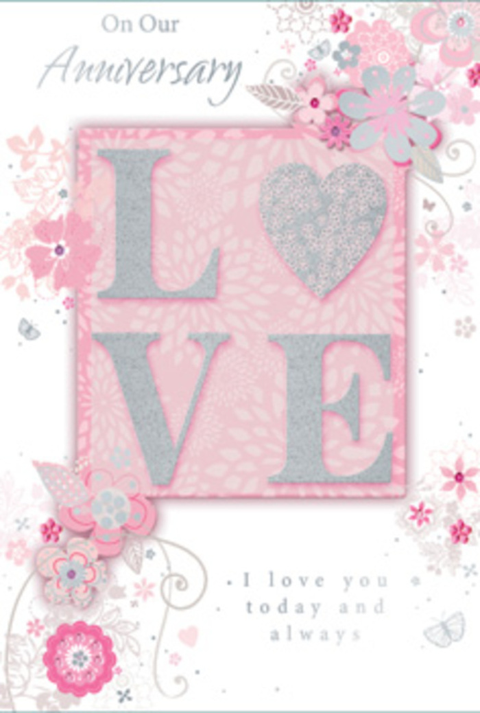 The anniversary card in this image feels like a gentle tribute to a love that has grown steadily over the years, much like the evolving skyline around the Barbican. At the centre, the word LOVE is displayed in large, raised letters that glimmer softly with blush pink glitter and pearly white highlights. The finish is subtly reflective rather than loud, catching just enough light to hint at movement as you tilt the card, and it appears pleasantly textured, almost like the surface of a carefully frosted petal. The background is a soothing wash of pale pink, layered with the faintest touches of white and soft grey that give the card a dreamy, cloud-like depth. Around this central motif, wispy, stylised blooms curl and drift, their petals stretched in graceful lines that mimic the airy stems of a hand-tied bouquet. The flowers are drawn in fine detail, with hints of silver foiling tracing select petals and leaves, much like a florist using a highlight of gypsophila or eucalyptus to add lightness to an arrangement. These flourishes loop and spiral across the edges of the card, giving a sense of motion and quiet joy, as if the design were slowly unfurling like blossoms opening on a calm spring day in nearby Postman's Park. The interior text, written in a refined script, expresses love, gratitude, and commitment in a tone that is both tender and sincere. Overall, the card feels like a paper echo of a romantic bouquet arranged by Barbican Flowers, ready to be paired with anniversary blooms for same-day local delivery.