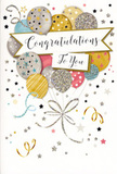 The photograph captures a tall congratulations card propped upright, its design evoking the light, buoyant feeling of stepping out into one of the Barbican's sunlit walkways after receiving good news. Prominently featured is a bouquet-like cluster of illustrated balloons, gathered tightly towards the centre and rising upwards. The balloons are drawn in harmonising shades of metallic gold, soft silver, champagne, pastel blue, gentle pink, and cool grey. Each balloon is trimmed with its own subtle decoration: some shimmer with tiny star shapes, others carry finely drawn stripes or delicate, glitter-like highlights that suggest a slight texture and shine across their rounded surfaces. Slim metallic ribbons in gold and silver tones flow from the base of the cluster, twisting and curling in elegant loops, reminiscent of festive streamers curling across a celebration table in a Barbican apartment. The background is intentionally soft and light, scattered with little stars, dots of confetti, and swirling ribbons that add a sense of movement and joy without cluttering the composition. Cutting gracefully through the centre of the design is a gently curved banner, edged in metallic detail and carrying a beautifully scripted congratulations message in flowing calligraphy. The overall effect is a card that feels timeless, refined, and full of quiet excitement-perfect for celebrating a graduation, a new role in one of the nearby City offices, or any special achievement. Paired with seasonal flowers, it would make a thoughtful finishing touch for deliveries throughout Barbican and the surrounding EC1 neighbourhoods.