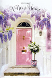 This scene captures a sun-washed entrance in the Barbican, styled with the kind of understated elegance a local florist might create for a special housewarming. A softly painted pink front door stands at the centre, its muted tone balanced by crisp white walls and a single shutter lightly brushed with the same blush hue, giving the façade a harmonious, almost storybook quality. Arching above, wisteria cascades in plentiful strands of lavender and pale purple, the blossoms hanging like fragrant tassels that frame the doorway with natural grace. The vine's foliage adds pockets of rich green, contrasting gently with the pastel surroundings, and casting lace-like shadows that drift across the door as the light moves, much like the quiet transitions of the day around nearby Barbican gardens and squares. On the doorstep itself, a sturdy, weathered bucket in soft grey cradles a generous bouquet of white and cream roses, their petals layered and plush, some edges just beginning to curl in a way that suggests velvety softness to the touch. Wisps of green foliage and delicate leafy stems weave between the roses, giving the arrangement a relaxed, hand-gathered feel, as though it had been placed there moments ago to greet the home's new occupants. A silky ribbon in gentle pink is wrapped around the bucket and tied into a loose bow, its ends draping gracefully, echoing the wisteria's downward sweep. The overall mood is one of tender celebration-a quiet yet heartfelt gesture perfect for congratulating someone on a new Barbican home, capturing that blend of excitement, comfort, and the intimate promise that this doorway will witness many happy arrivals and reunions.